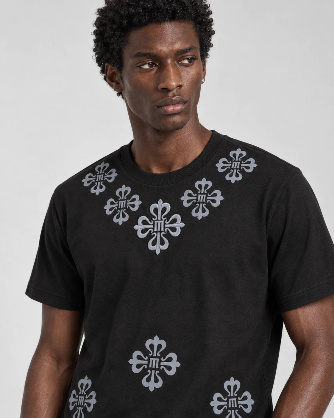 MOMANI Emblem Yoke T-Shirt in Black, worn by a model, close detail