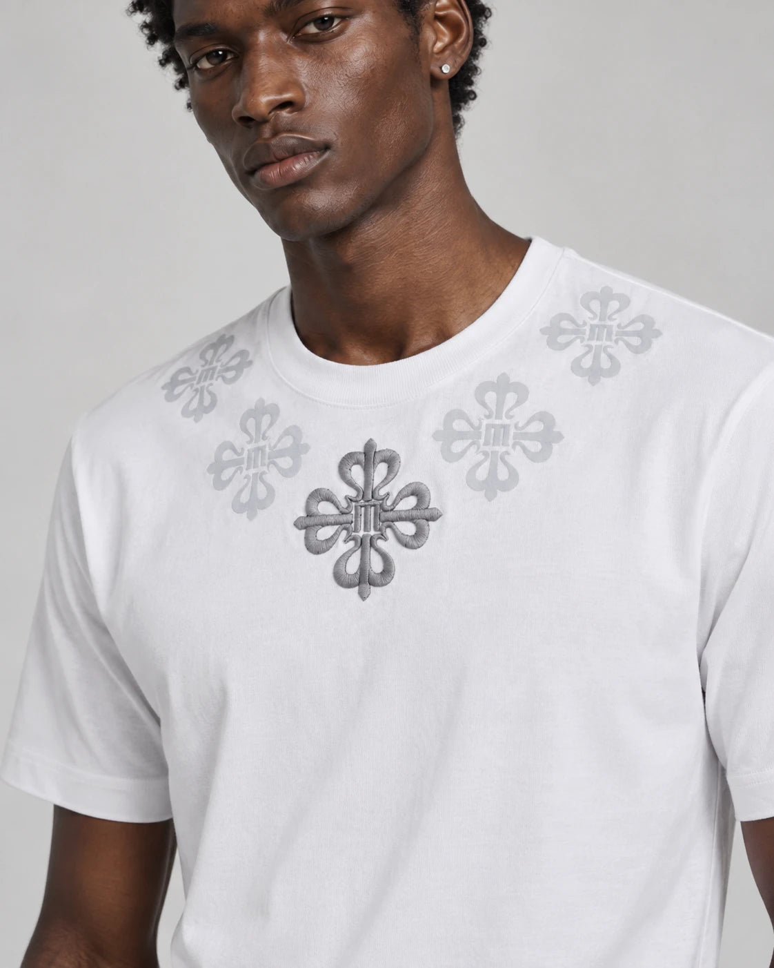 MOMANI Emblem Yoke T-Shirt in White, worn by a model, close detail