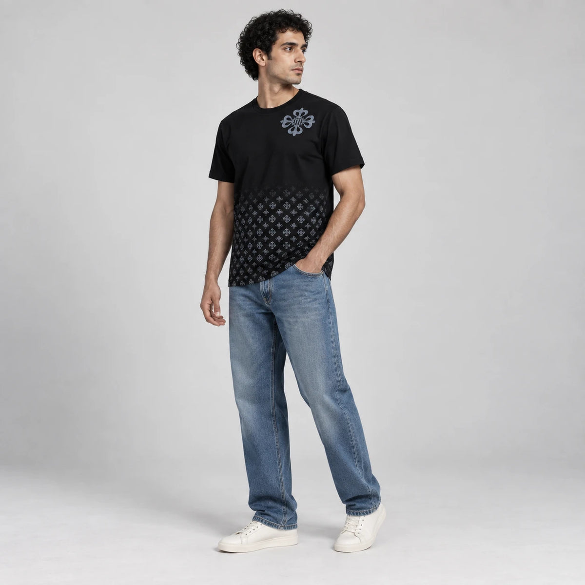 MOMANI Emblem Crest T-Shirt in Black, worn by a model, three-quarter view