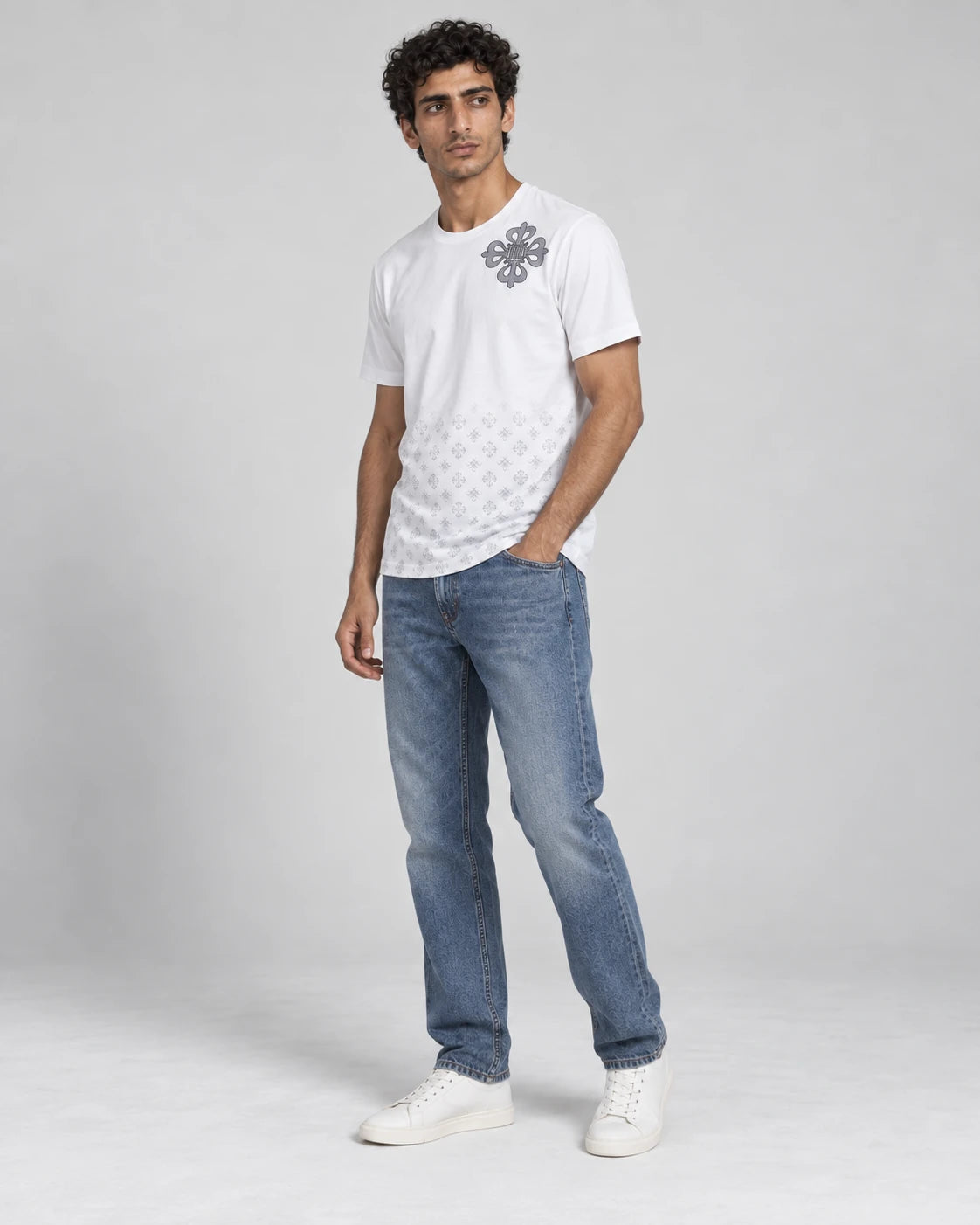 MOMANI Emblem Crest T-Shirt in White, worn by a model, three-quarter view