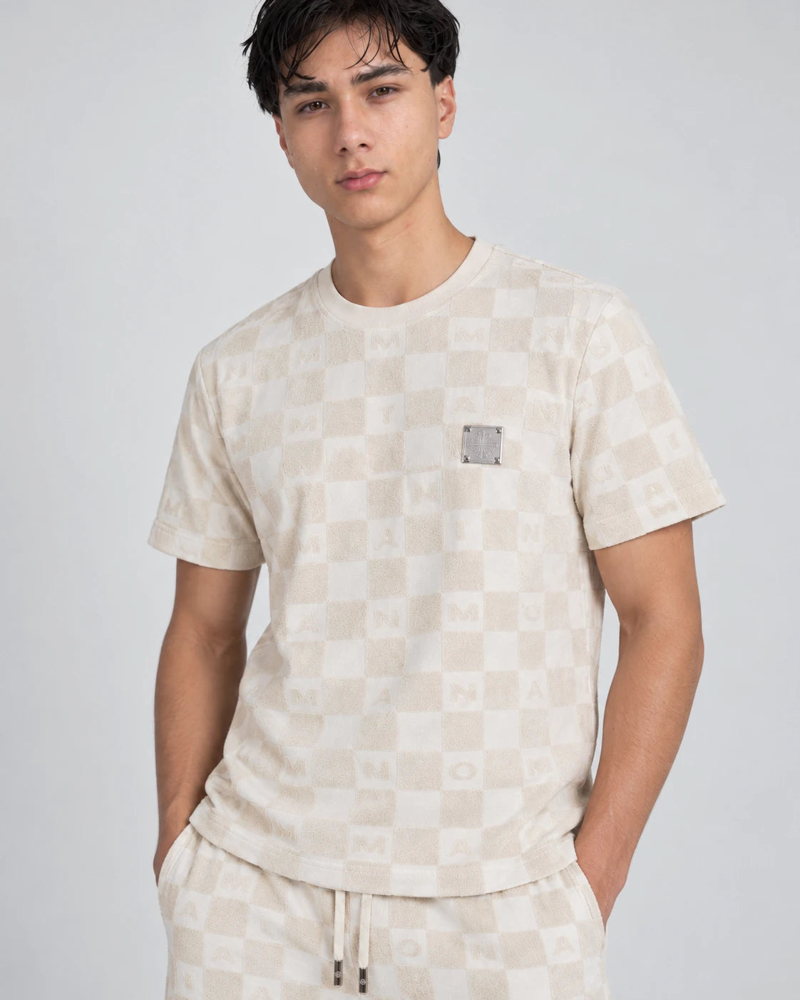 MOMANI Monogram Check T-Shirt in Cream, worn by a model, close detail