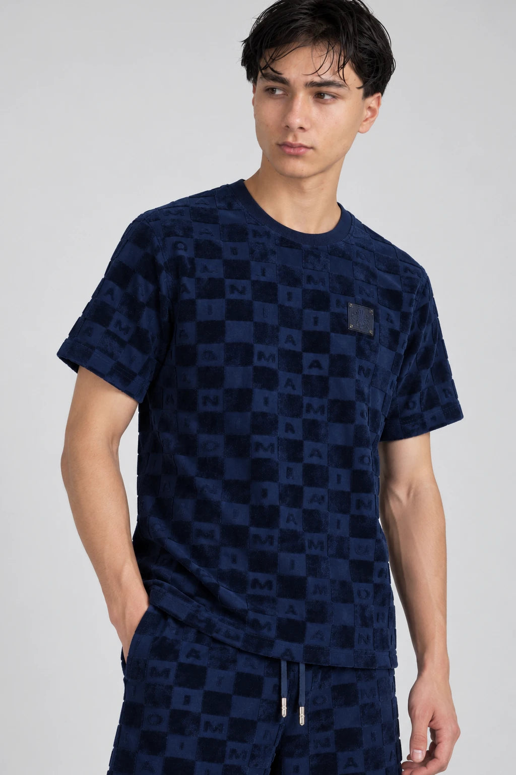 MOMANI Monogram Check T-Shirt in Navy, worn by a model, close detail