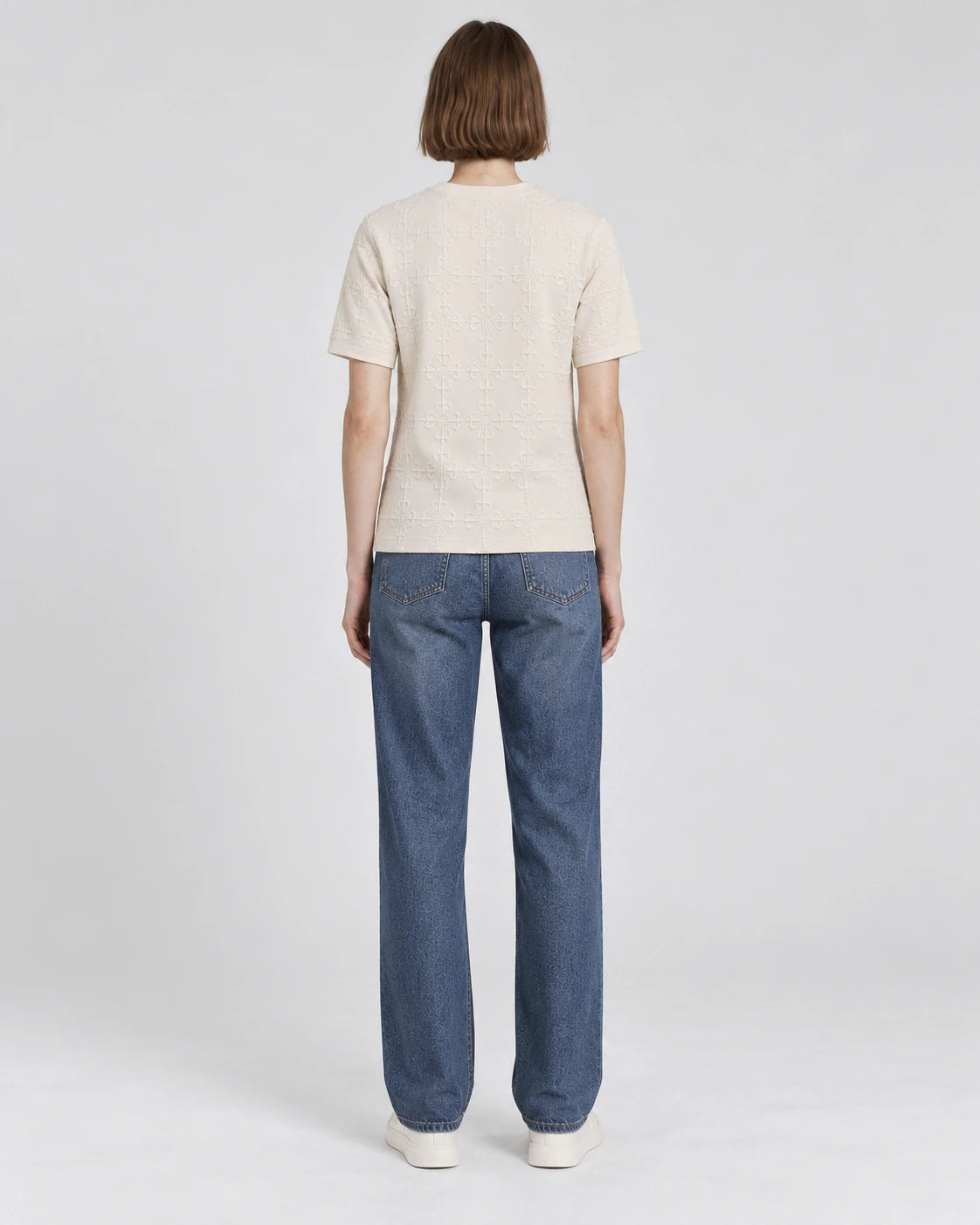 MOMANI Emblem Relief T-Shirt in Cream, worn by a model, back view