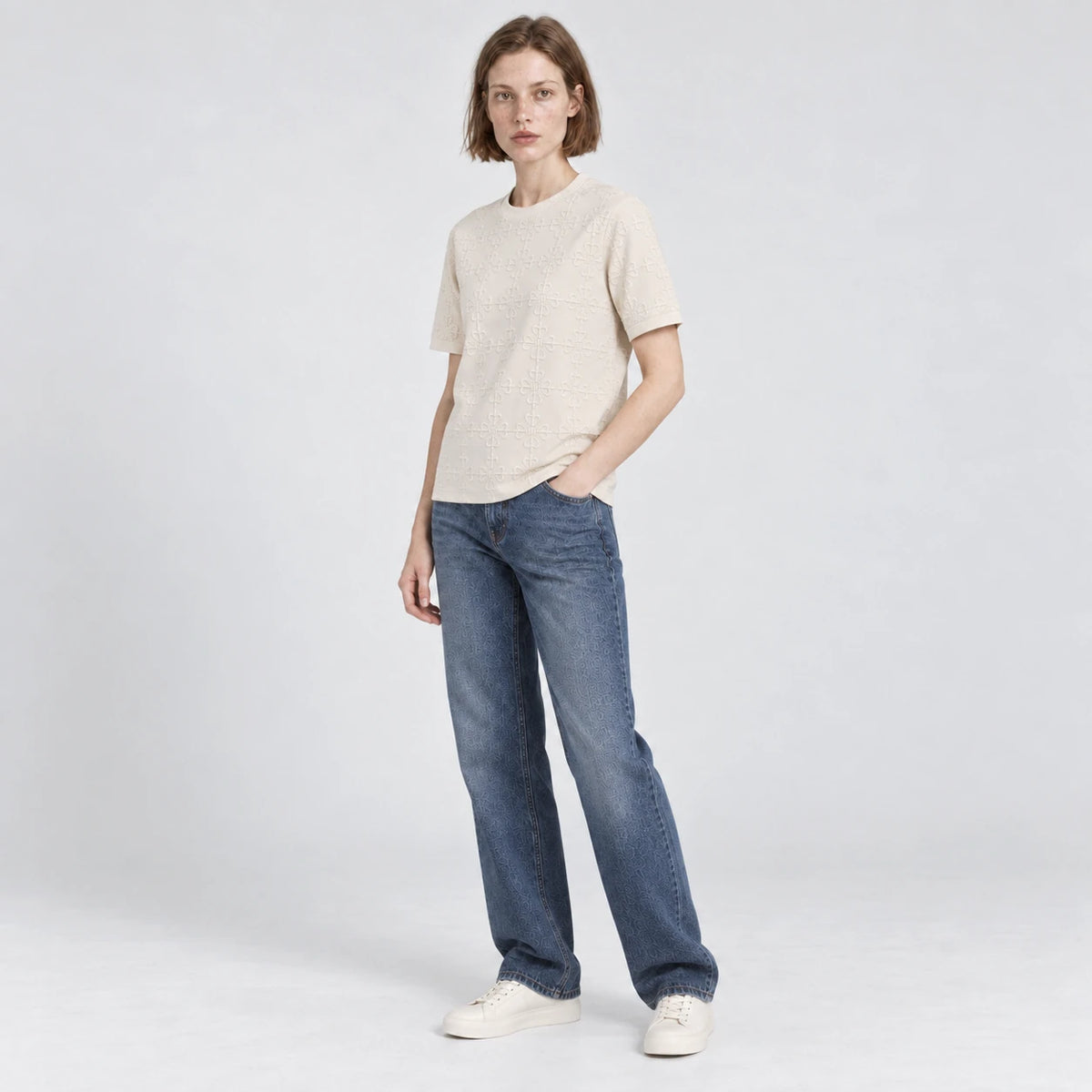 MOMANI Emblem Relief T-Shirt in Cream, worn by a model, three-quarter view
