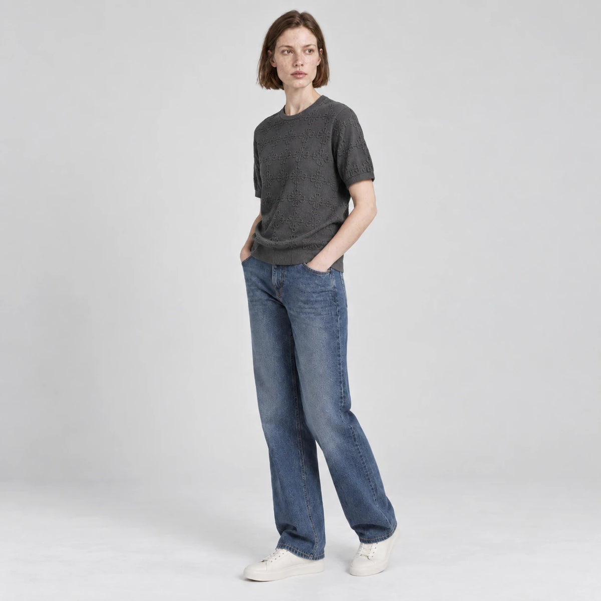 MOMANI Emblem Relief T-Shirt in Grey, worn by a model, three-quarter view