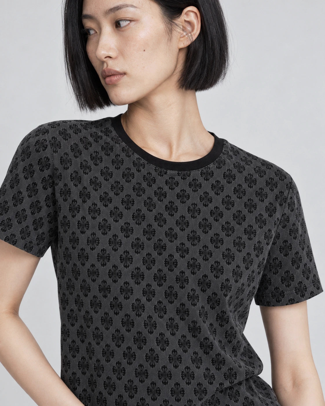MOMANI Micro Emblem T-Shirt in Black, worn by a model, close detail