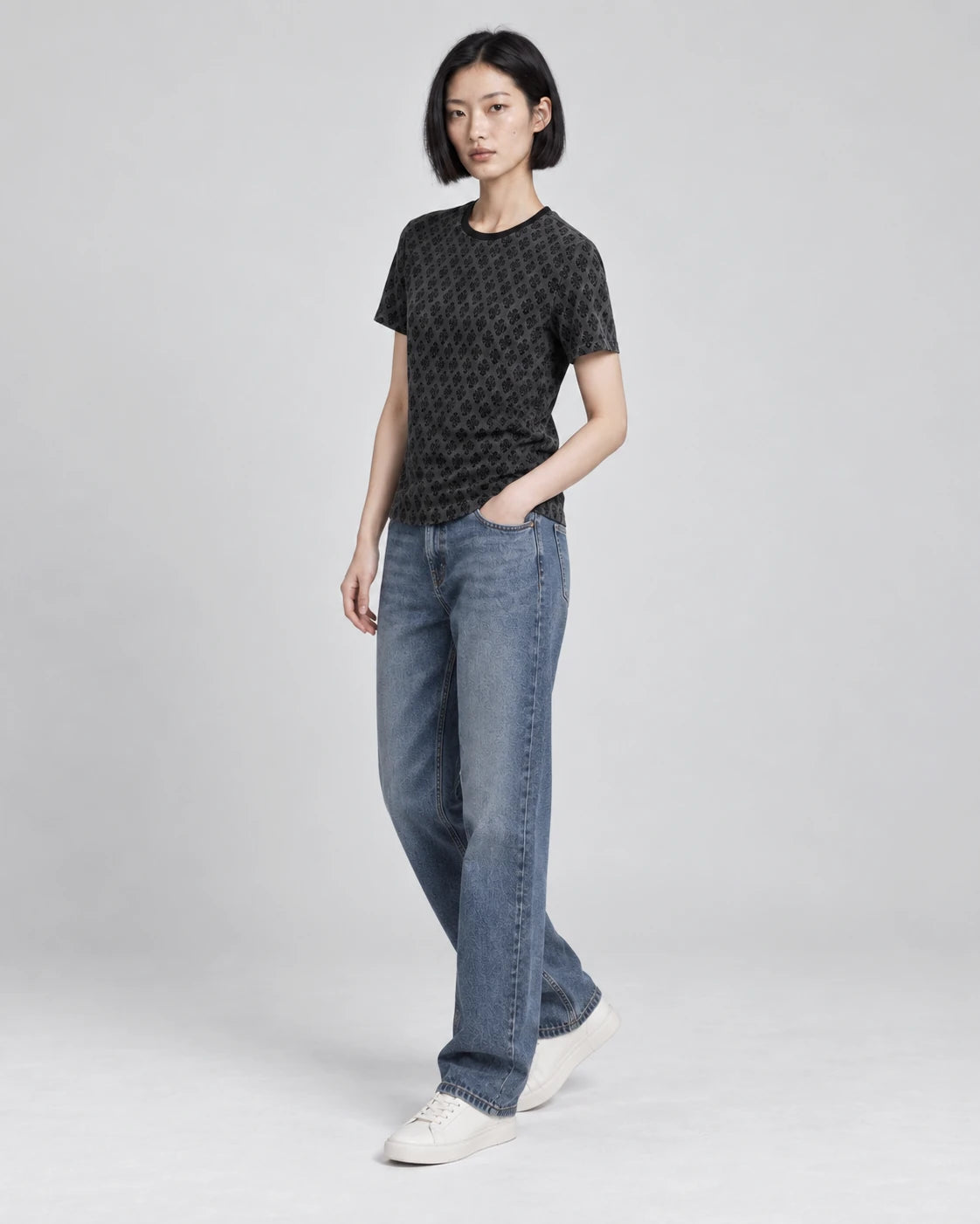 MOMANI Micro Emblem T-Shirt in Black, worn by a model, three-quarter view