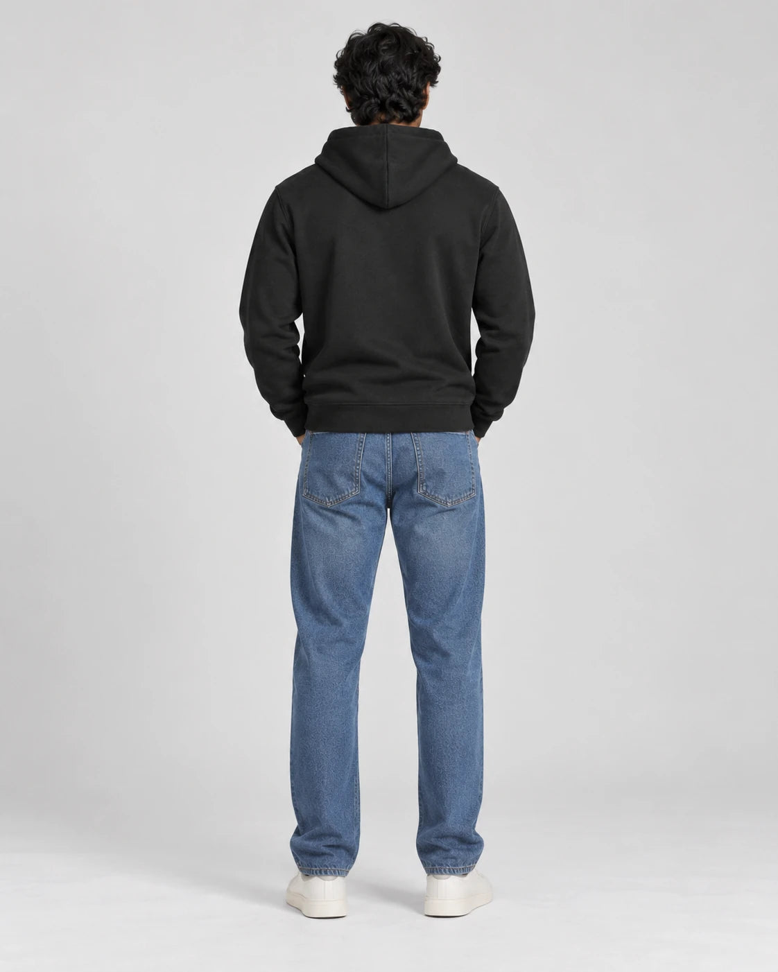 MOMANI Essential Hoodie in Black, worn by a model, back view