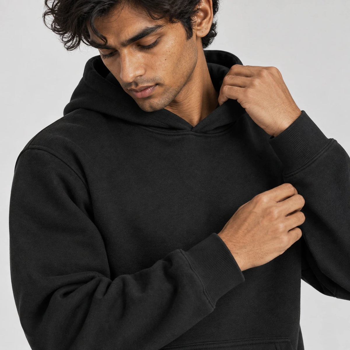 MOMANI Essential Hoodie in Black, worn by a model, close detail