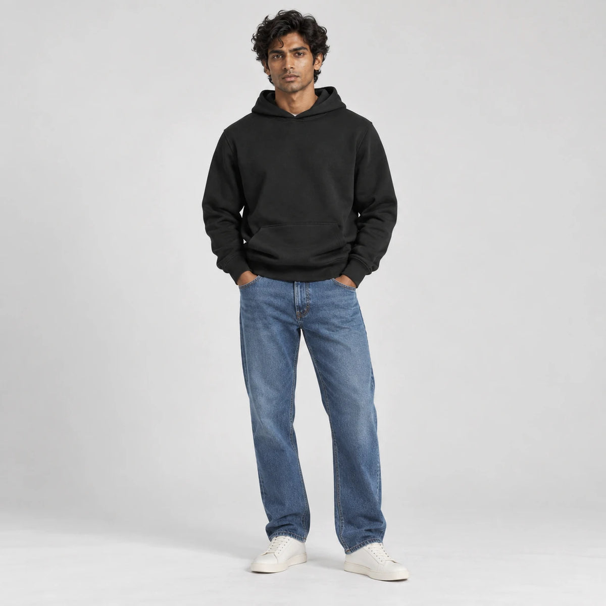 MOMANI Essential Hoodie in Black, worn by a model, front view