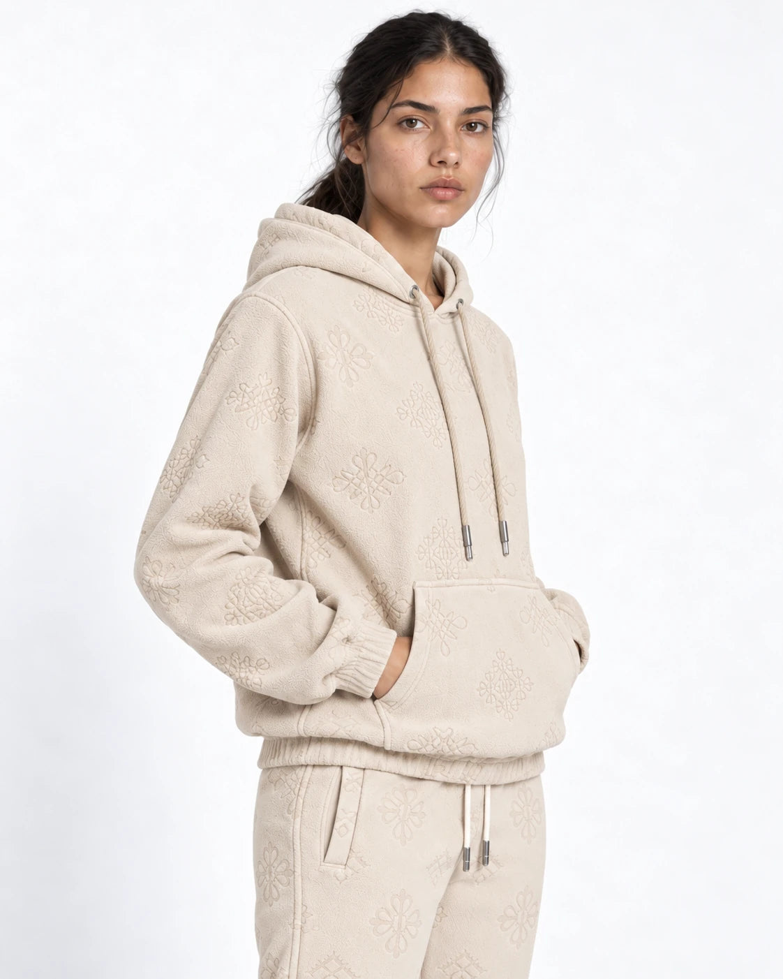MOMANI Emblem Jacquard Hoodie in Cream, worn by a model, close detail