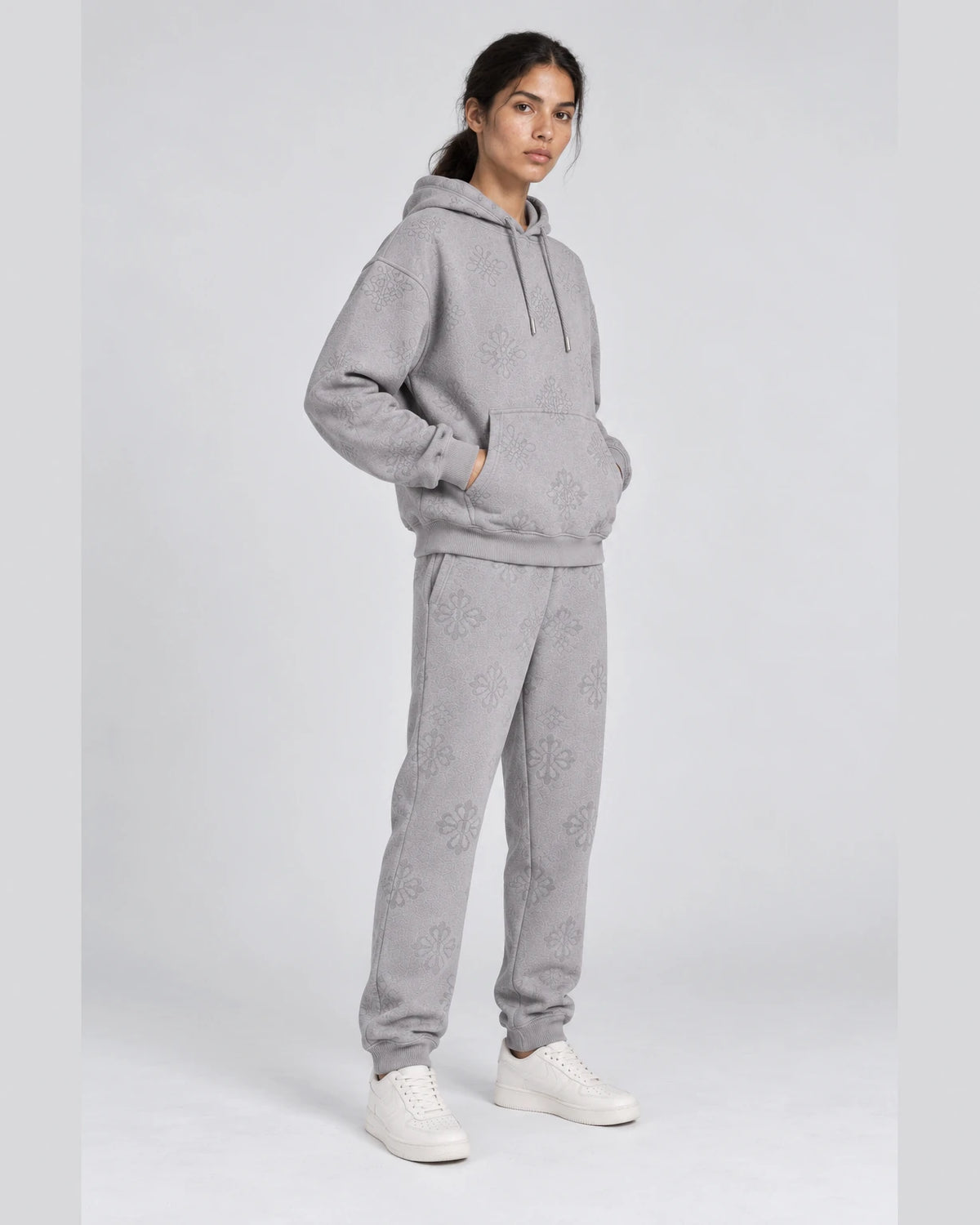 MOMANI Emblem Jacquard Hoodie in Grey, worn by a model, three-quarter view