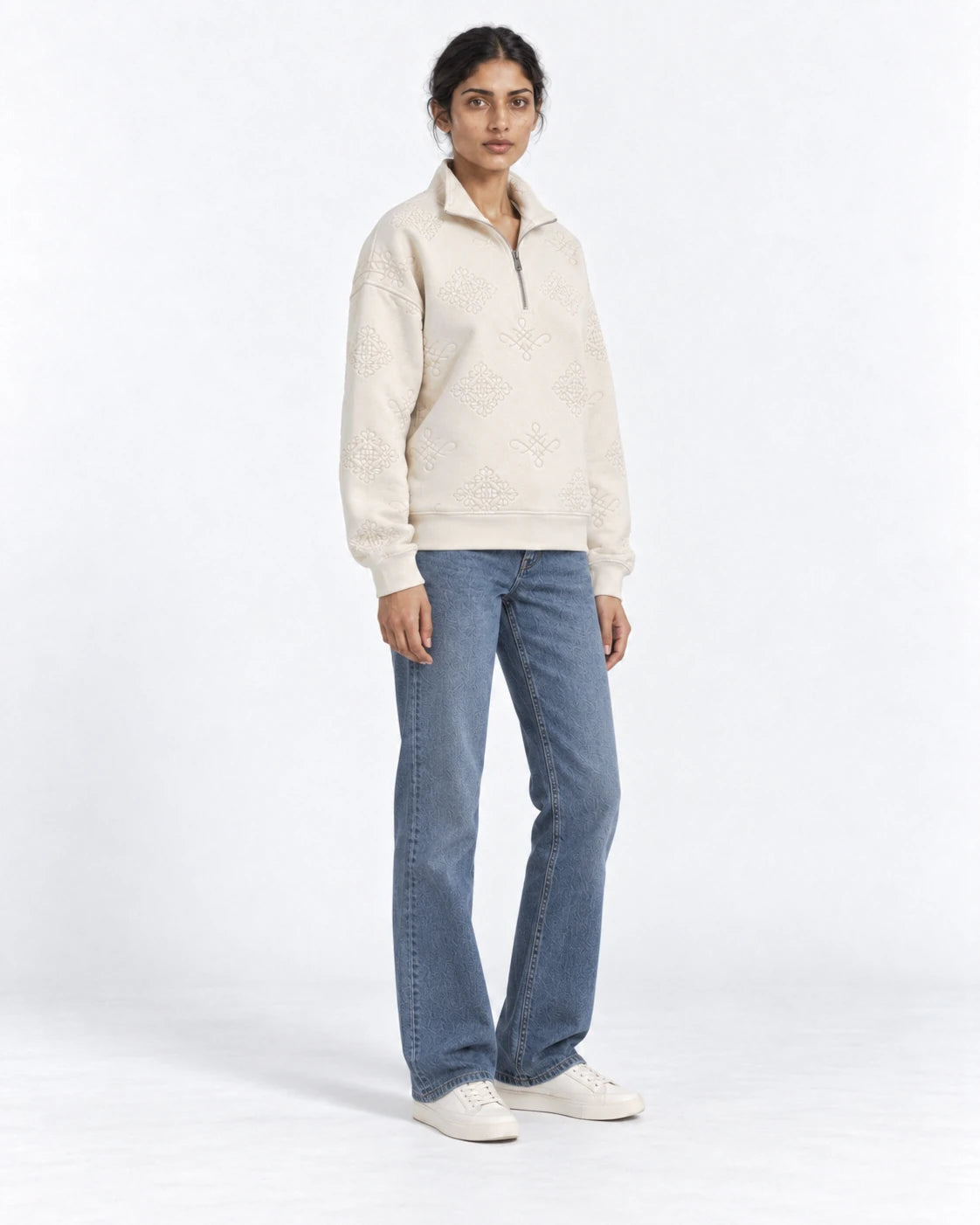 MOMANI Emblem Quarter-Zip Sweatshirt in Cream, worn by a model, three-quarter view