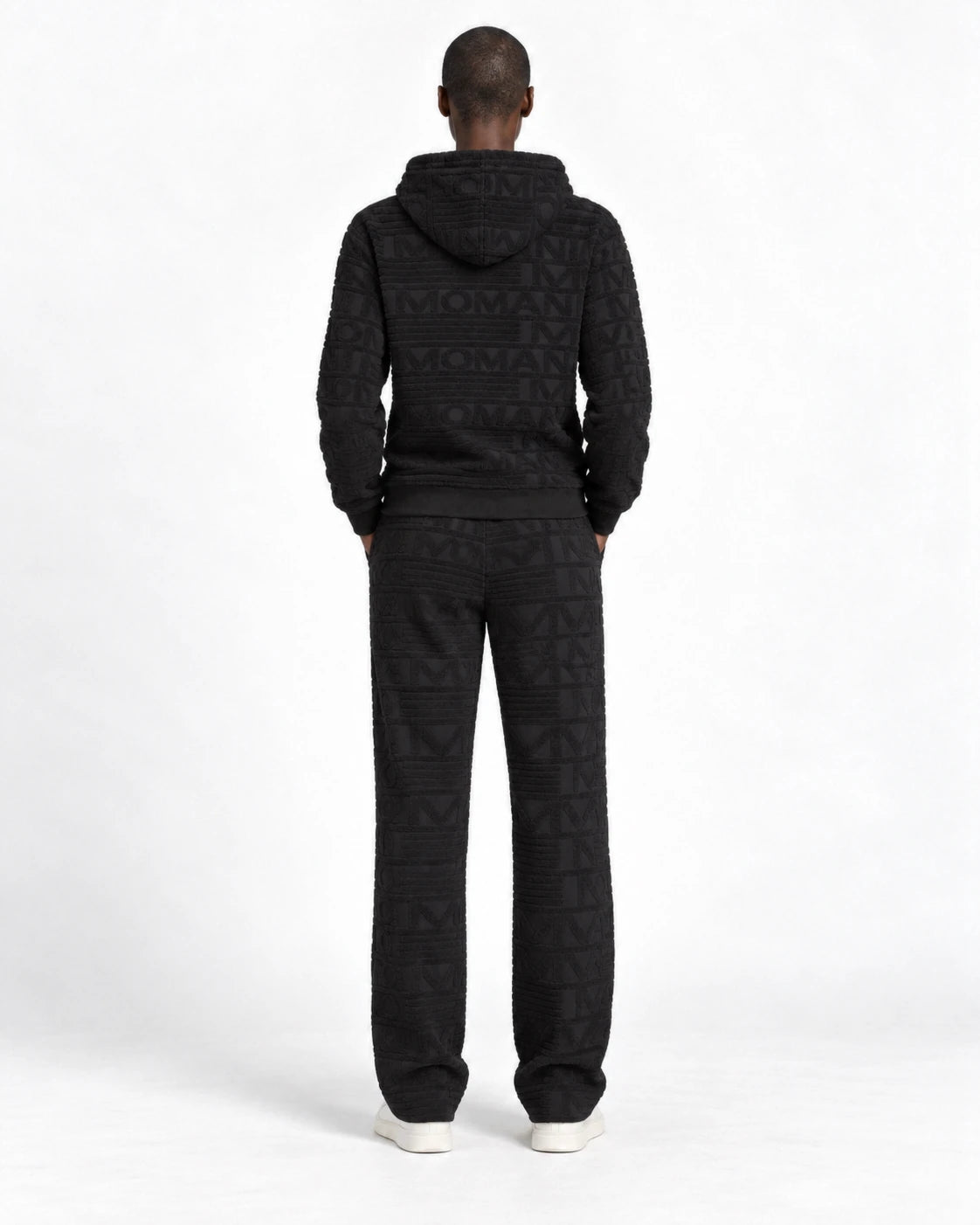 MOMANI Emblem Terry Hoodie in Black, worn by a model, back view