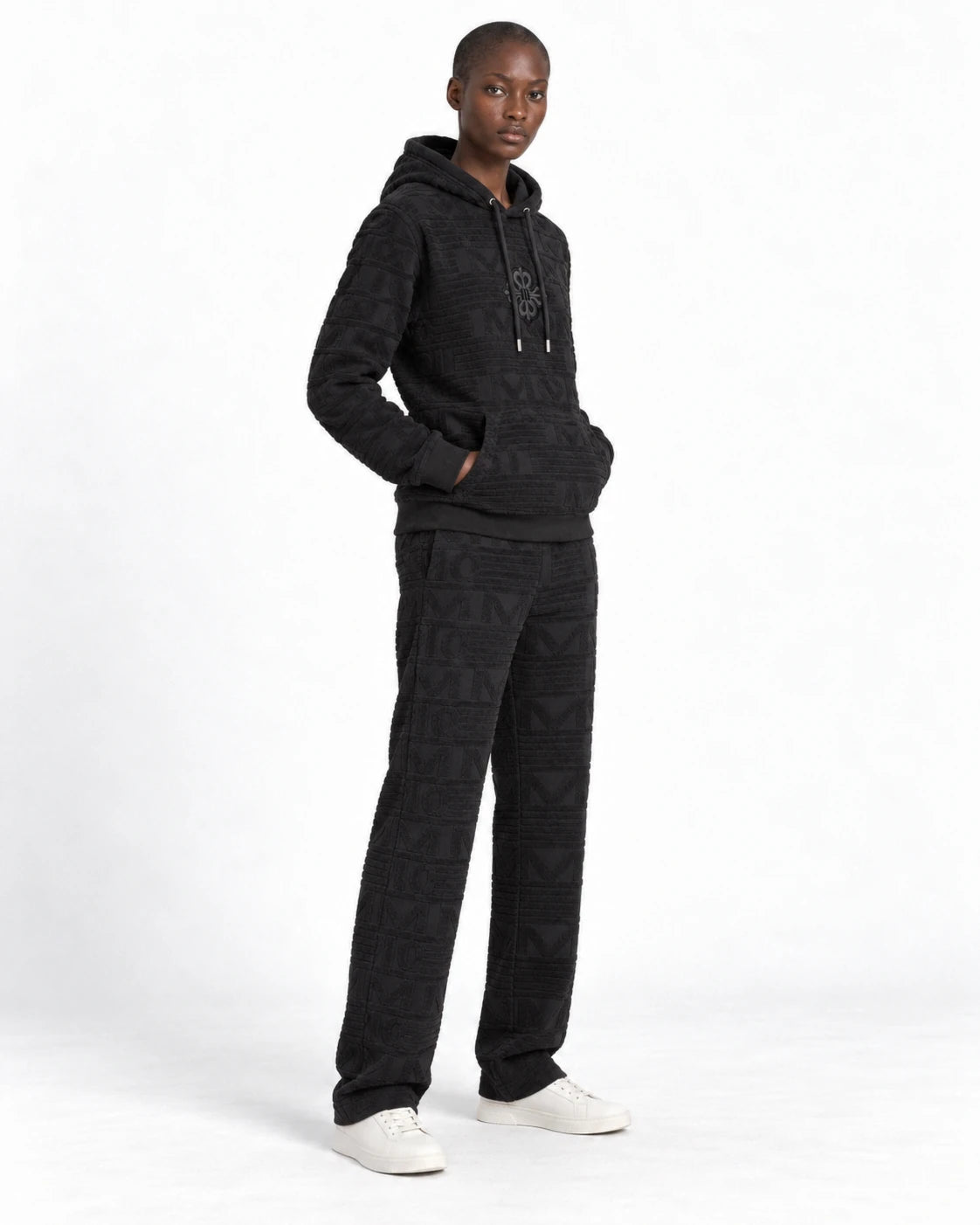 MOMANI Emblem Terry Hoodie in Black, worn by a model, three-quarter view