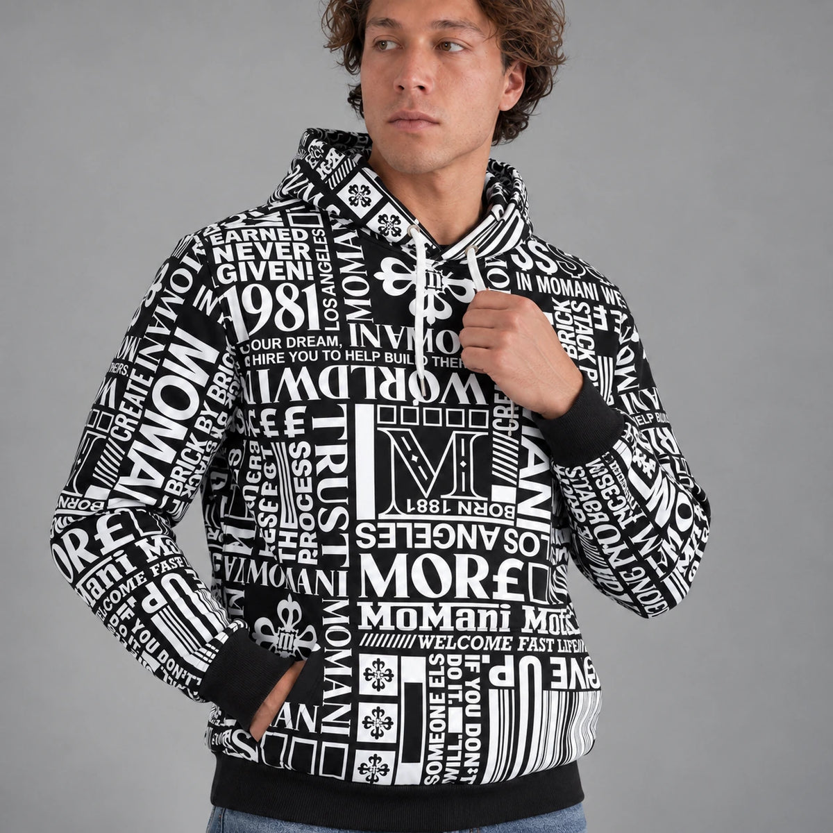 MOMANI Typographic Hoodie in Black, worn by a model, close detail