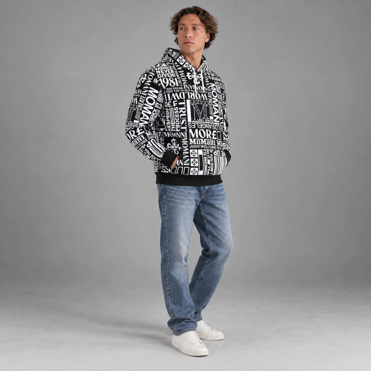 MOMANI Typographic Hoodie in Black, worn by a model, three-quarter view