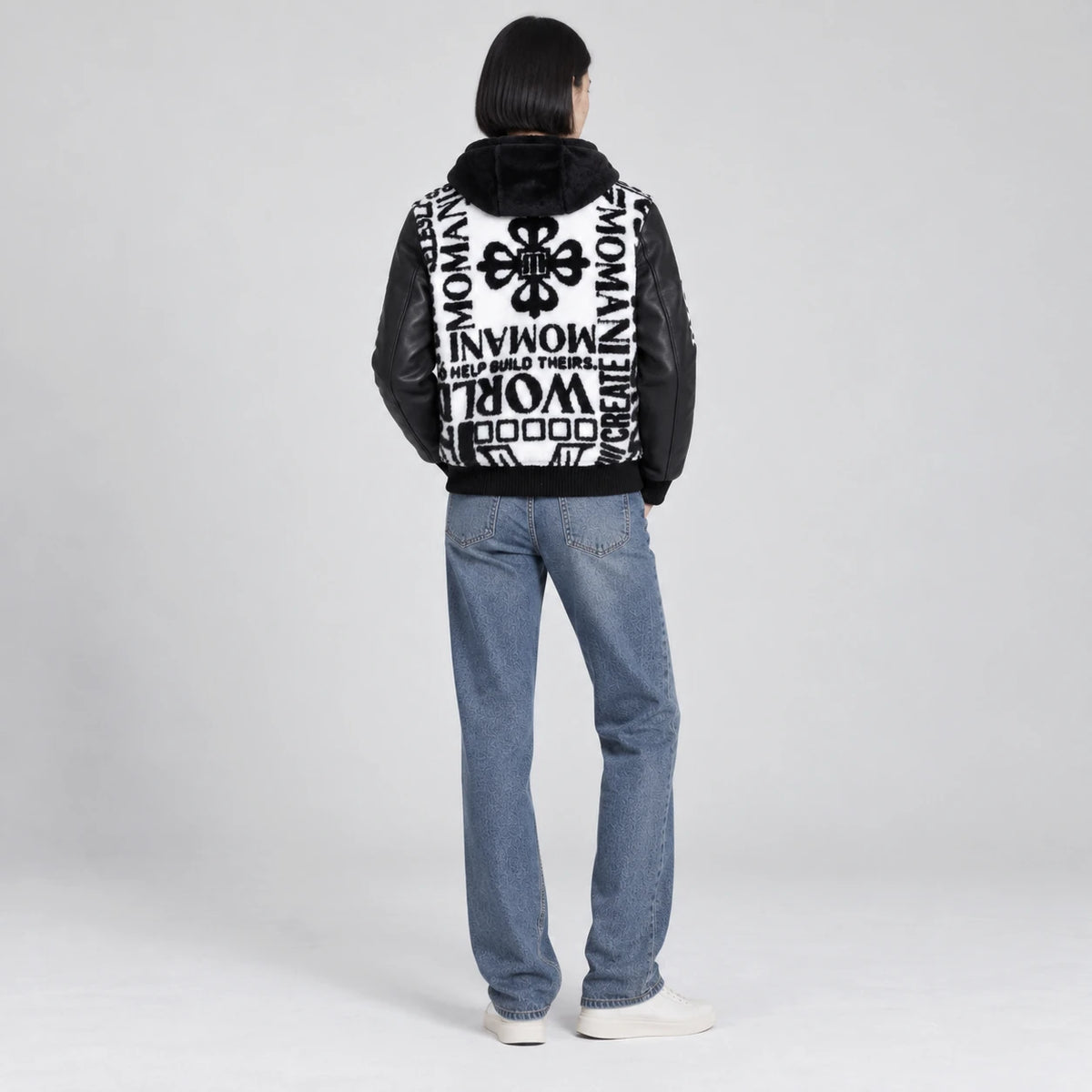 MOMANI Typographic Hooded Coat in Black, worn by a model, back view